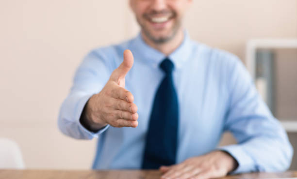 istock Businessman Offering Hand For Handshake Sitting In Office, Cropped 1239229585