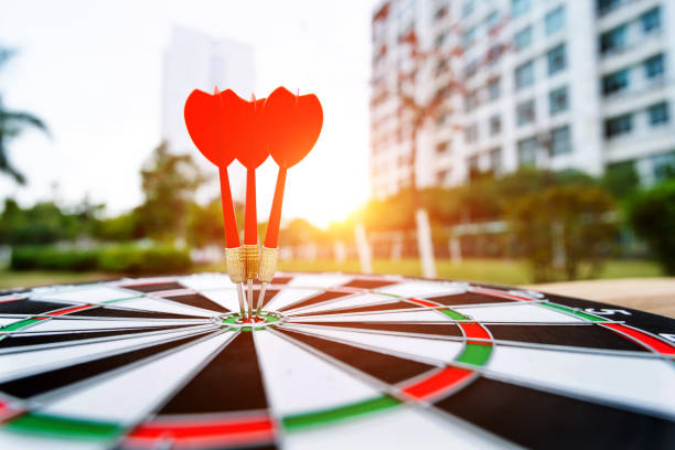 istock Three darts on dart board outdoors 1239233815