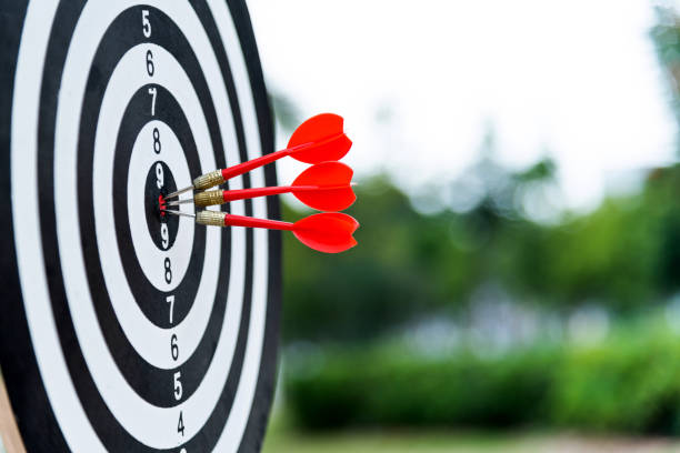Three darts on dart board outdoors