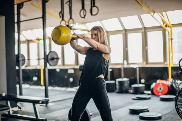 istock Fit young woman training with kettlebell 1239246233