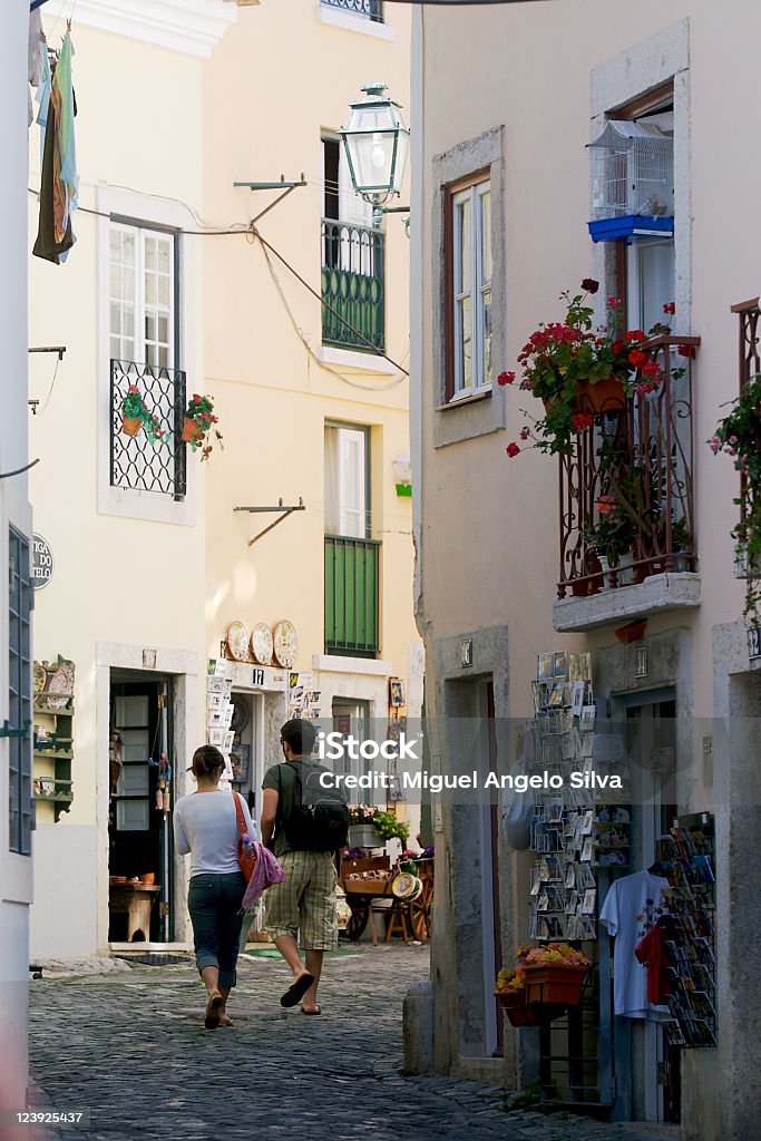 Lisbon street and couple Couple of tourists walking on a old Lisbon street and visiting souvenir shops Lisbon - Portugal Stock Photo