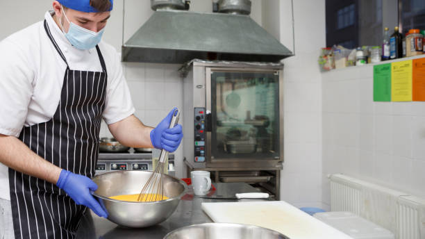 istock Man beating eggs with a whisk on take away kitchen 1239260517