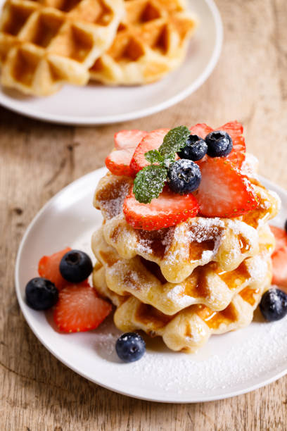 istock belgian waffles with fresh blueberries, strawberries and sugar. 1239263830