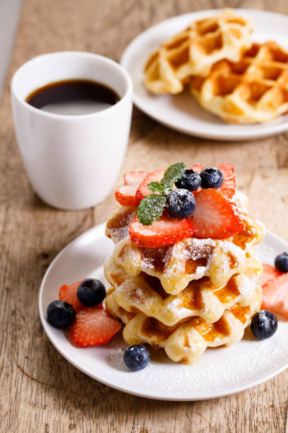 istock belgian waffles with fresh blueberries, strawberries and sugar. 1239263840