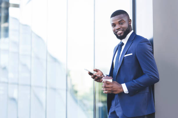 istock Business Guy Texting On Cellphone Standing Outdoors In Urban Area 1239263882