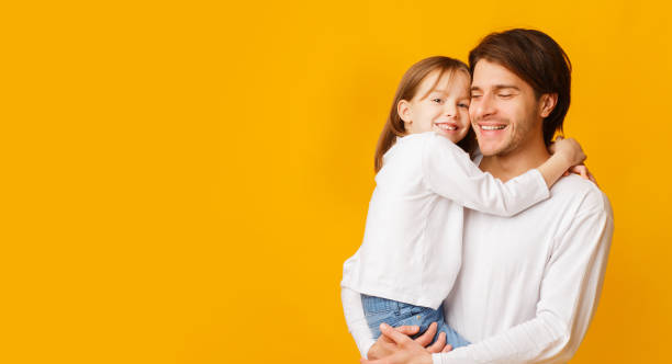 istock Pretty little girl hugging her handsome father 1239266608