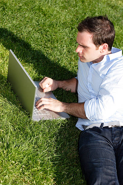 istock Man Lies on Grass with Laptop 123927057