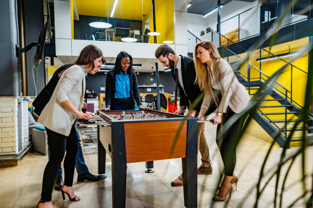 istock Businesspeople playing foosball in office 1239282480