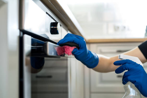 woman doing kitchen cleaning chores with rubber gloves and rag. cleaning concept. woman doing kitchen cleaning chores with rubber gloves and rag. cleaning concept cleaning stove domestic kitchen human hand stock pictures, royalty-free photos & images