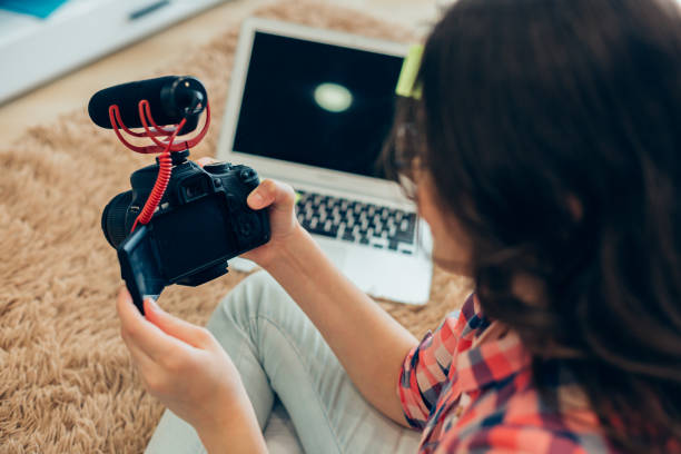 istock Modern camera with microphone in hands of careful child 1239318885
