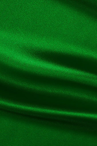 Green satin background.