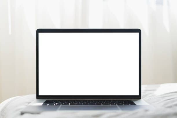 istock Mock up Blank screen laptop on the bed for advertising and text. 1239348014