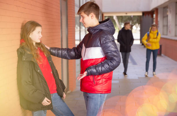 istock Two teenage students talking near college 1239350174