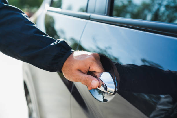 istock Male hand open the car door pulling the handle of a car. 1239351243