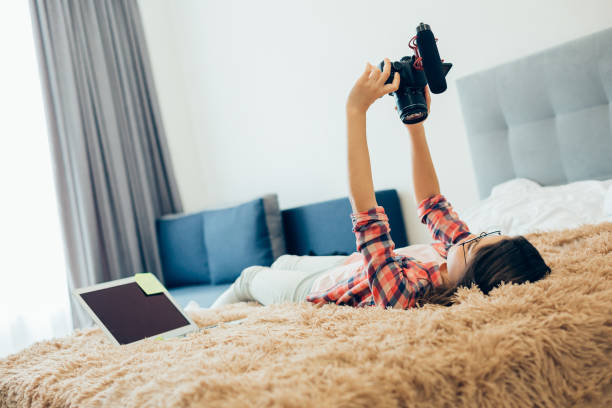 istock Amateur blogger making videos at home with modern camera 1239354972