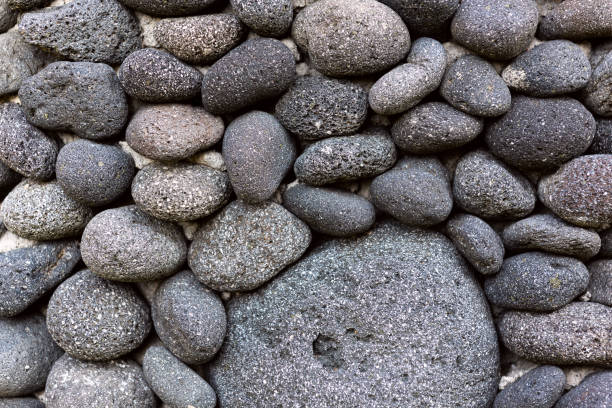 istock Dark grey black sea stones background. 1239360320