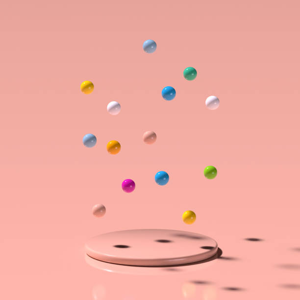 istock Colorful plastic balls fly on a round platform on a pale pink background. 3D render. 1239373299