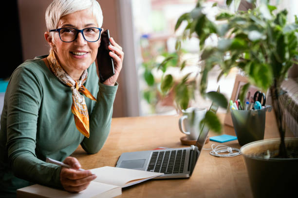 istock Mature woman working indoors at home 1239374412