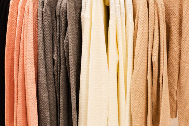 istock texture of multi-colored sweaters hanging on a trempel, closeup. 1239375422