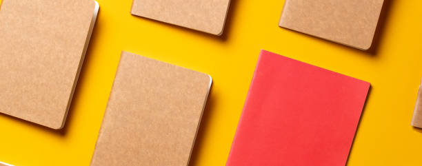 istock creativity content marketing concept,.top view of red notebook align in pattern on yellow table background.mockup for advertise content online.unique idea 1239376571