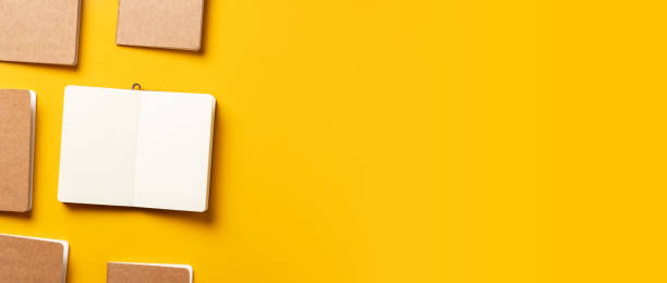 istock content marketing concept,.top view of hand writing on open notebook align with kraft paper book in pattern on yellow table background.mockup for advertise content online 1239378694