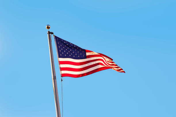 istock Stars and stripes under clear blue sky 1239387752