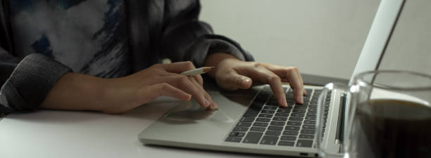 istock Female freelancer writing an e-mail on laptop while sitting at portable workspace 1239397018
