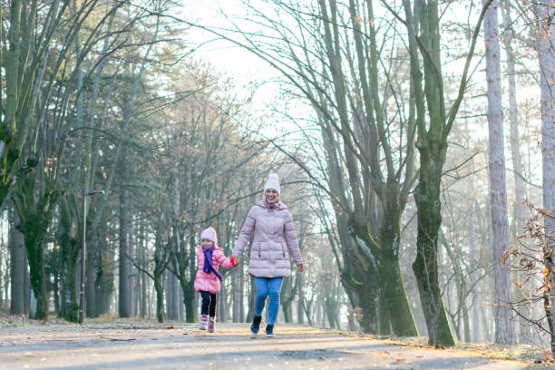 istock Mother and daughter walking in nature 1239401791