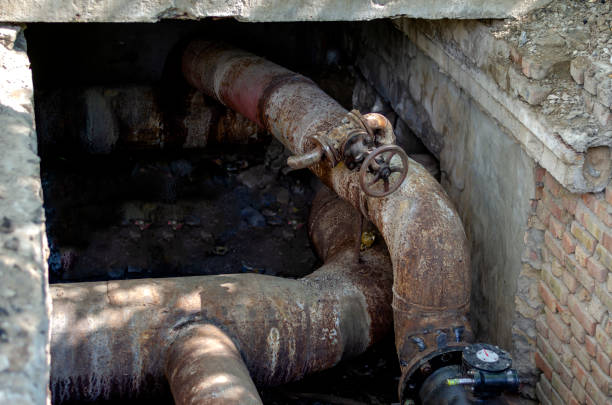 istock An open underground pipeline with valves in a brick well. 1239426474