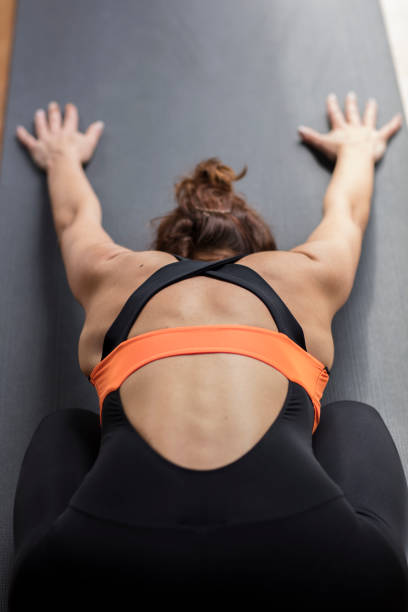 istock Young Woman Practicing Yoga in a Green Background 1239429679