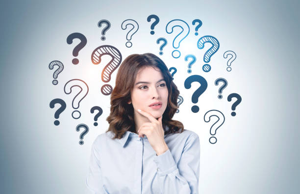 istock Thoughtful young woman and question marks 1239432974