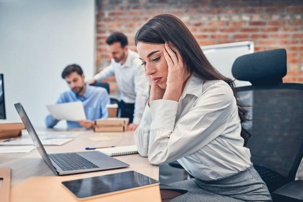 istock Pretty young woman using laptop in the office 1239434668