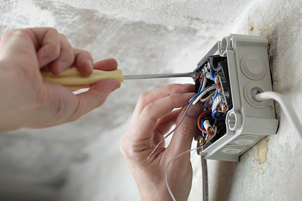 trabalhador usando uma chave de parafusos para instalar caixa eléctricos - electrical contractor imagens e fotografias de stock