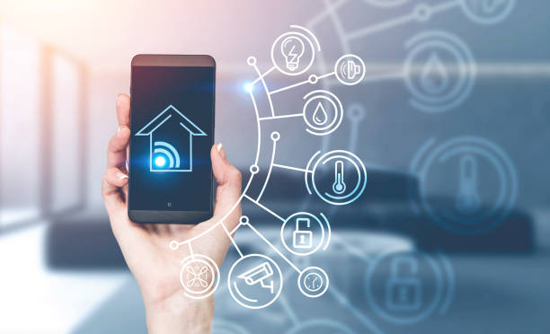 istock Woman hand with phone, smart home interface 1239448023