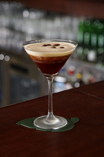 A glass of classic espresso martini on the bar counter