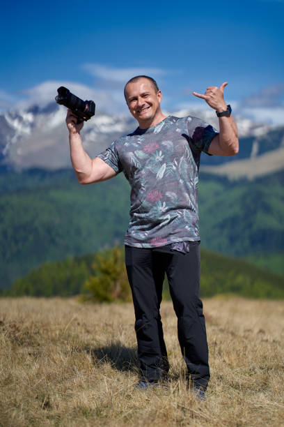 istock Man with camera in the mountains 1239454799