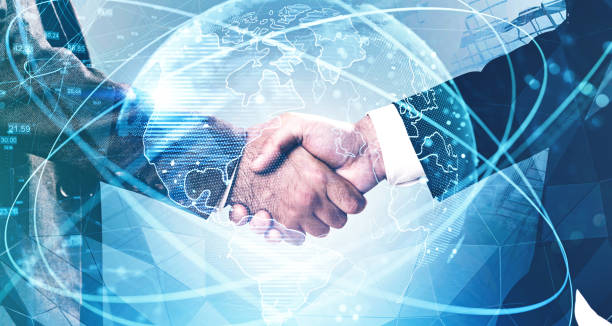 Men shaking hands in city, network interface Close up of two businessmen shaking hands in city with double exposure of blurry network interface and planet hologram. Concept of internet and partnership. Toned image global business handshake stock pictures, royalty-free photos & images