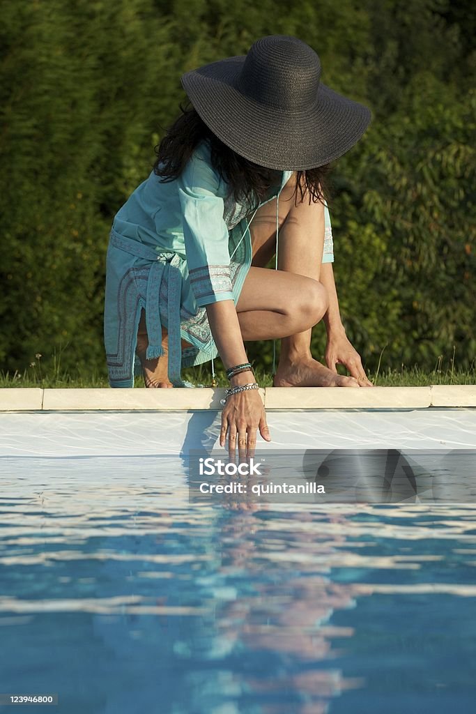 stoop testing water woman barefoot at swimming pool border in Asturias Spain Adult Stock Photo