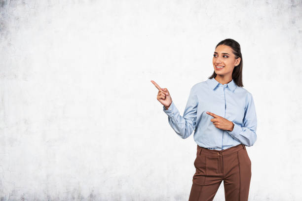 istock Cheerful businesswoman pointing at copy space 1239472124