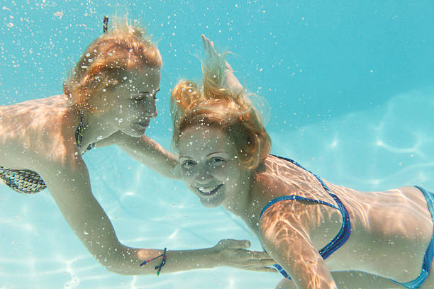 istock underwater girls in swimming pool 123947392