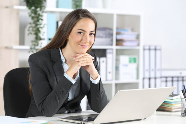 istock Happy executive poses looking at camera at office 1239516423