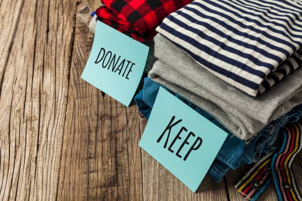 istock Stack of old clothes to discard (declutter) or keep. Recycle clothes, eco cotton 1239522997