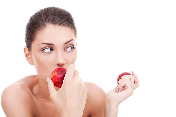 istock woman eating peaches 123954712