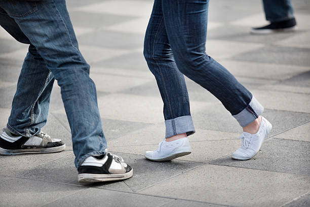istock Two pairs of legs dancing on square-tiled pavement 123956889