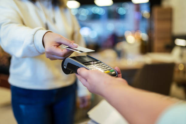 Furniture store owner receives contactless payment due to social distancing stock photo