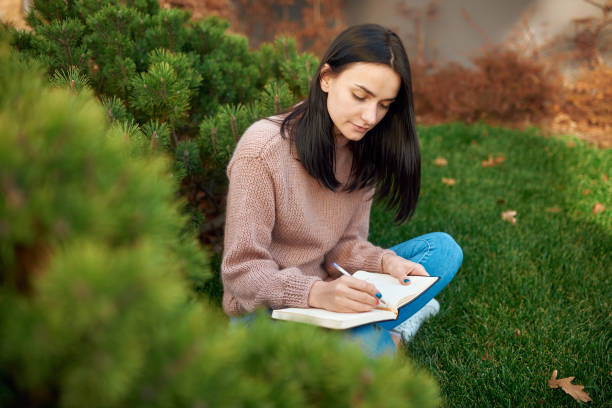 Tender female doing paperwork on a cosy sward