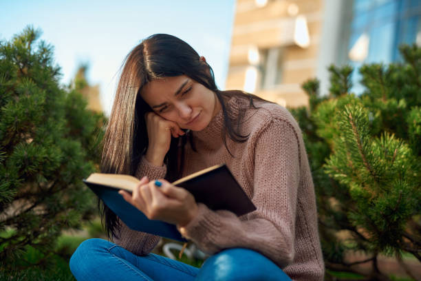 istock Pensive female student studying outdoors preparing for exams 1239594189