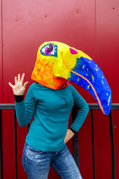 istock Woman's wearing bird head mask 1239596012