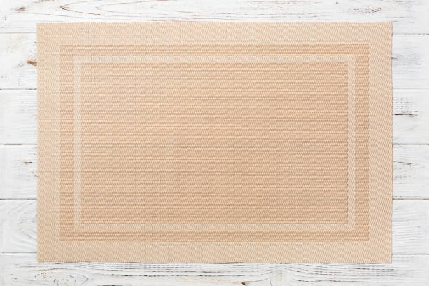istock Top view of textile brown mat for dinner on wooden background with copy space 1239596550