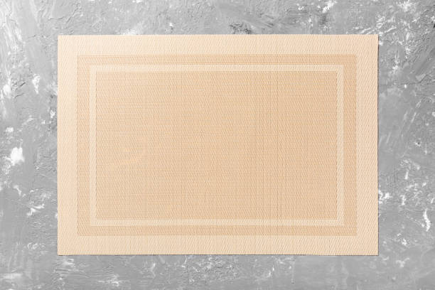 istock Top view of textile brown mat for dinner on cement background with copy space 1239597659
